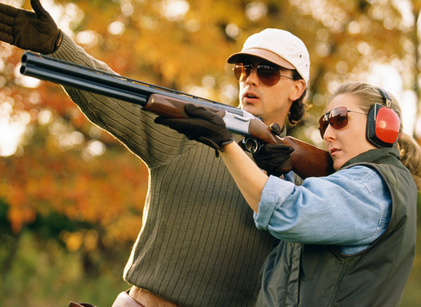 man-showing-woman-how-to-shoot-trap